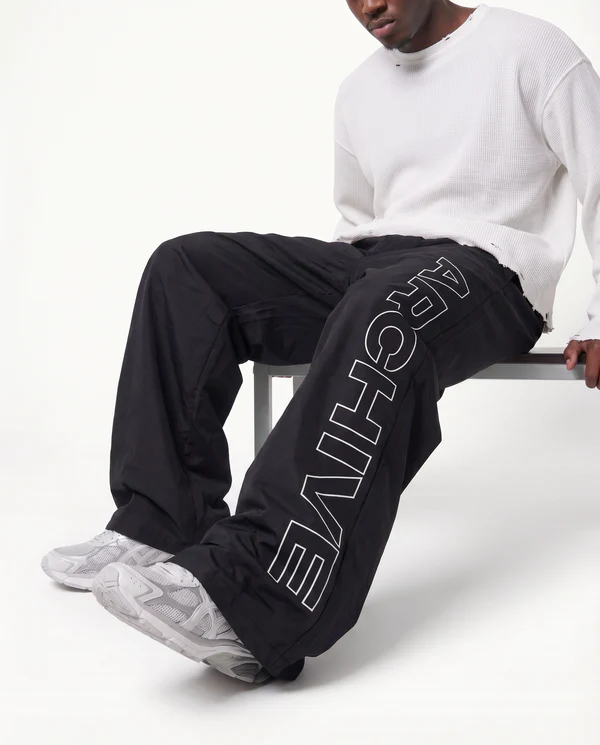 freepik__img2-to-recreate-the-pose-the-model-is-doing-but-w__27675 ARCHIVE 'STATEMENT' NYLON PANTS - BLACK